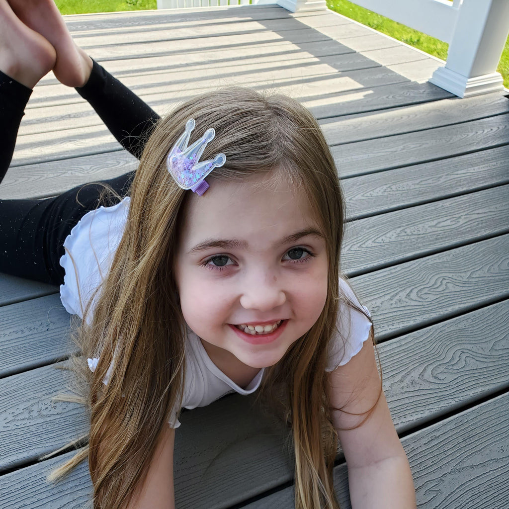 little girl wearing a lavender glitter crown shaker no slip hair clip